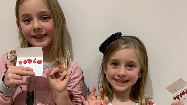 Helping others: Matilda, 9, and Alice, 6, are two of the participants in the world-first study that has confirmed the at-home blood test works and is accurate. Image: Supplied.