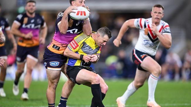 Grant Atkins slows down Tyson Smoothy of the Broncos.