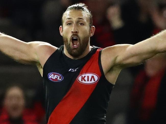 MELBOURNE, VICTORIA - AUGUST 12:  Cale Hooker of the Bombers celebrates after kicking a goal during the round 21 AFL match between the Essendon Bombers and the Adelaide Crows at Etihad Stadium on August 12, 2017 in Melbourne, Australia.  (Photo by Scott Barbour/AFL Media/Getty Images)