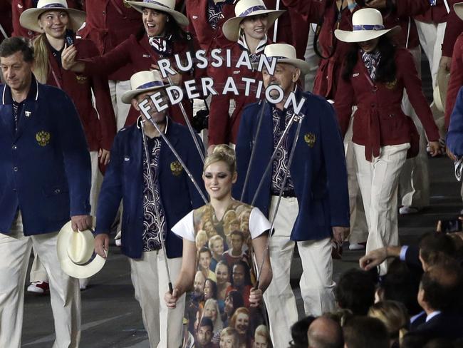 FILE - In this July 27, 2012 file photo Russia's Maria Sharapova carries the flag during the Opening Ceremony at the 2012 Summer Olympics in London. The credibility of the fight against doping in sports will be at stake Friday, June 17, 2016 when track and field's world governing body decides whether to uphold or lift its ban on Russian athletes ahead of the Rio de Janeiro Olympics. Sports geopolitics â€” and the key issue of individual justice vs. collective punishment â€” frame the debate heading into the meeting of IAAF leaders in Vienna. (AP Photo/Paul Sancya, file)