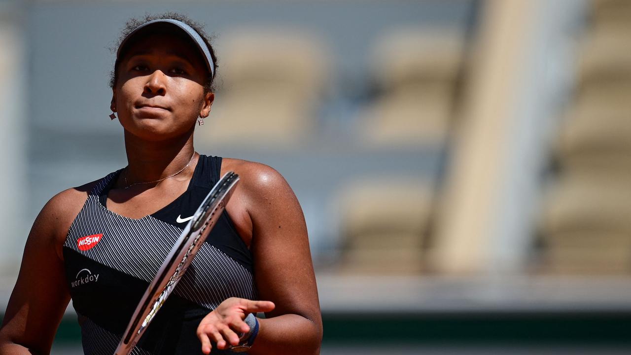 (FILES) In this file photograph taken on May 30, 2021, Japan's Naomi Osaka celebrates after winning against Romania's Patricia Maria Tig during their women's singles first round tennis match on Day 1 of The Roland Garros 2021 French Open tennis tournament in Paris. – Naomi Osaka said May 31, 2021, that she is withdrawing from the French Open following the bitter fallout from her decision to boycott all media activity. (Photo by MARTIN BUREAU / AFP)