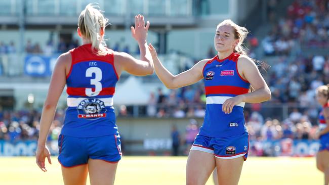 Isabel Huntington high fives Katie Brennan during last year’s season opener against Fremantle. Pic: Getty Images