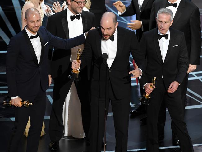 Prior to learning of the error, La La Land producers Fred Berger, Jordan Horowitz and Marc Platt accept the Best Picture award. Picture: Getty Images