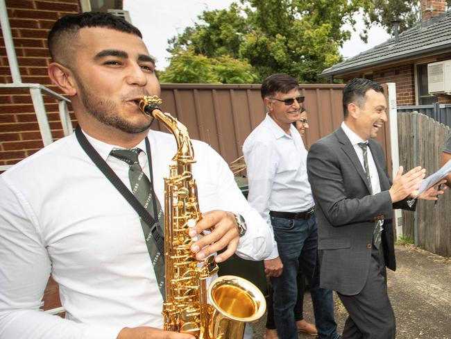 Auctioneer Chris Scerri brings the gavel down on 24, Moree Avenue in Westmead on 17th October 2020.The buyer Jai Singh (young chap with beard) was serenaded by musician Tarkan Yavuzceh on saxophone.(pictures by Julian Andrews).