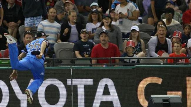 Ben Laughlin flies over the boundary to start the amazing catch process.