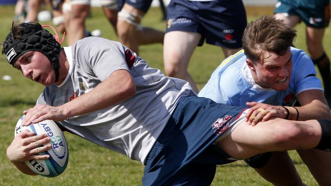 Queensland Reds' Dominic Kallquist is tackled by Waratahs Marshall La Maitre in the U18s match last year. Picture: John Appleyard