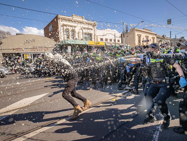 Police deploy pepper spray. Picture: Jason Edwards