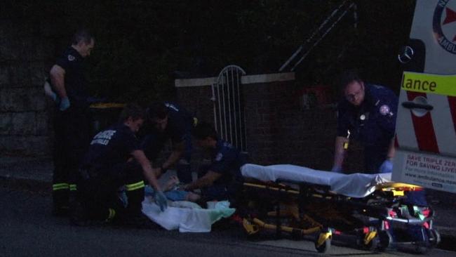 Paramedics treat the woman at the scene. Picture: TNV