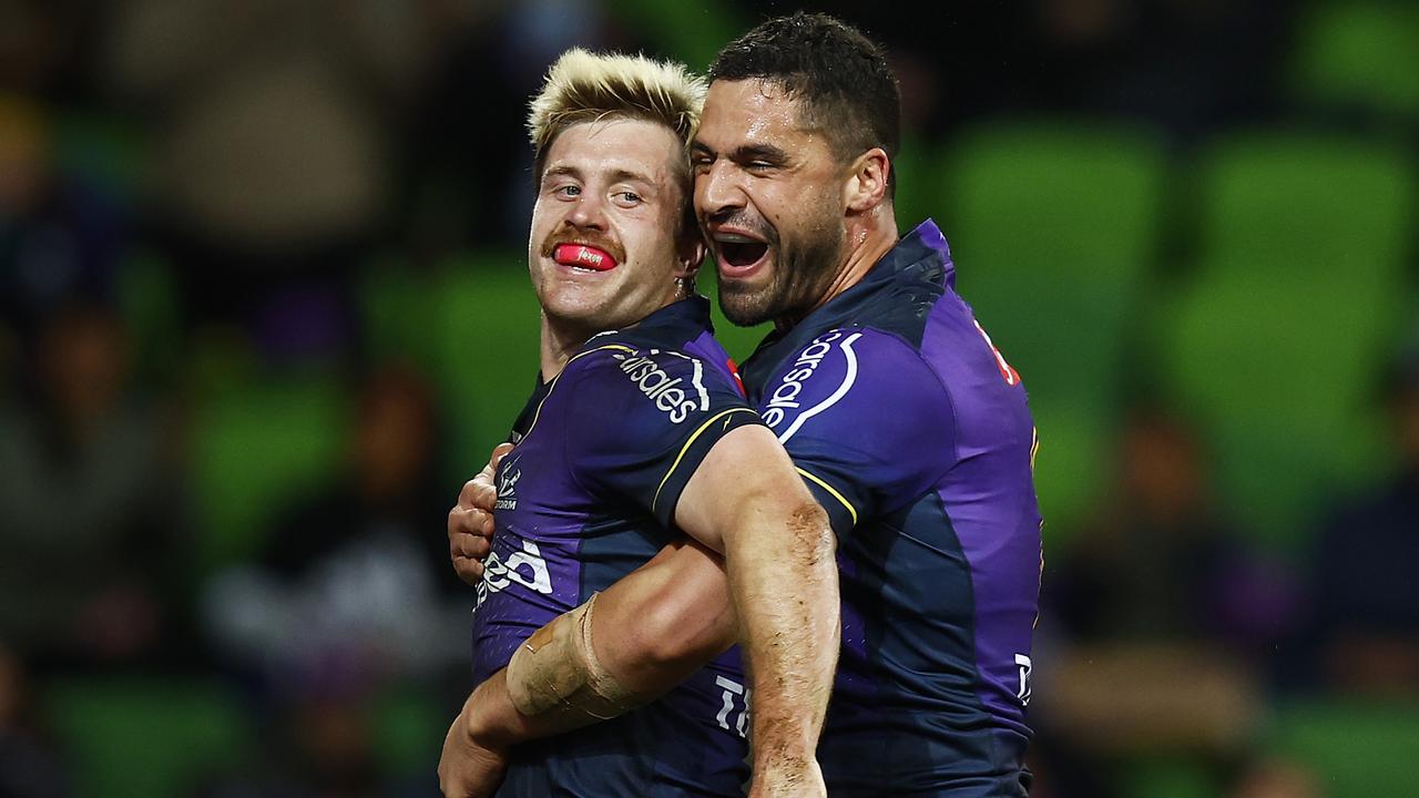 MELBOURNE, AUSTRALIA - AUGUST 05: Cameron Munster of the Storm (L) celebrates with Jesse Bromwich of the Storm after scoring a try during the round 21 NRL match between the Melbourne Storm and the Gold Coast Titans at AAMI Park, on August 05, 2022, in Melbourne, Australia. (Photo by Daniel Pockett/Getty Images)