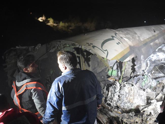 Pakistani officials of Pakistan International Airlines (PIA) look at the wreckages of crashed PIA passenger plane Flight PK661 at the site in the village of Saddha Batolni in the Abbottabad district of Khyber Pakhtunkhwa province on December 7, 2016. All 48 people on board a Pakistani plane which crashed in the country's mountainous north and burst into flames have died, officials told AFP on December 7, 2016. "No one survived," said the Civil Aviation Authority spokesman. / AFP PHOTO / AAMIR QURESHI