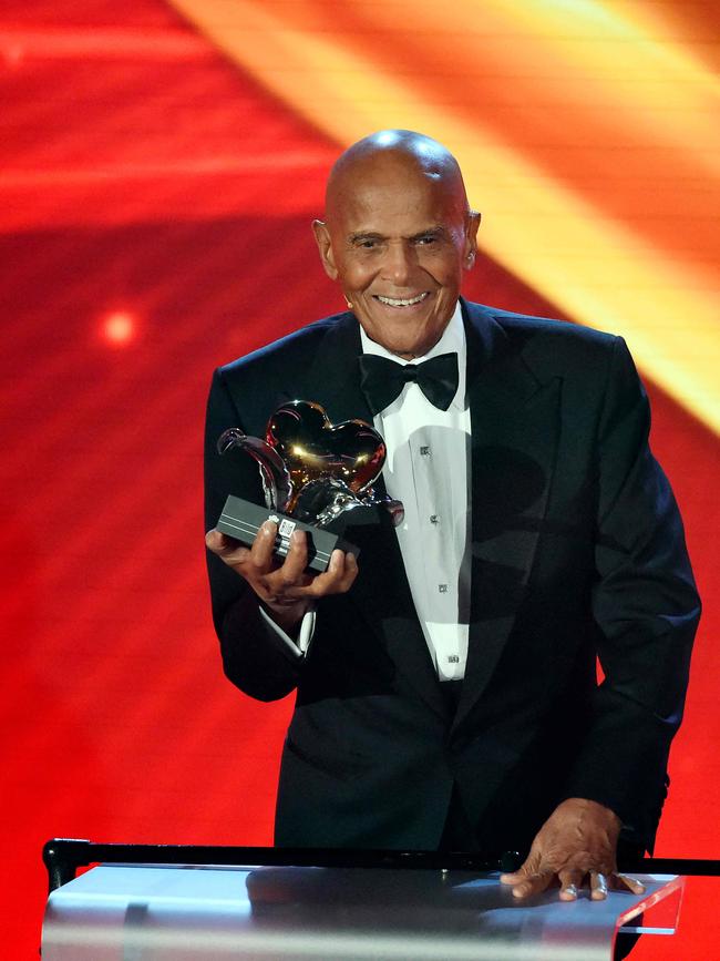 Harry Belafonte holds his Golden Heart award for his social commitment in 2014. Picture: AFP.