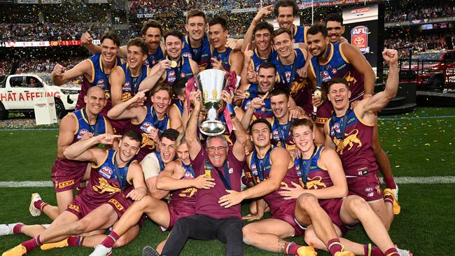 MELBOURNE, AUSTRALIA - SEPTEMBER 28: Brisbane Lions players and coach Chris Fagan, celebrate with the Premiership Cup after winning the AFL Grand Final match between Sydney Swans and Brisbane Lions at Melbourne Cricket Ground, on September 28, 2024, in Melbourne, Australia. (Photo by Quinn Rooney/Getty Images)