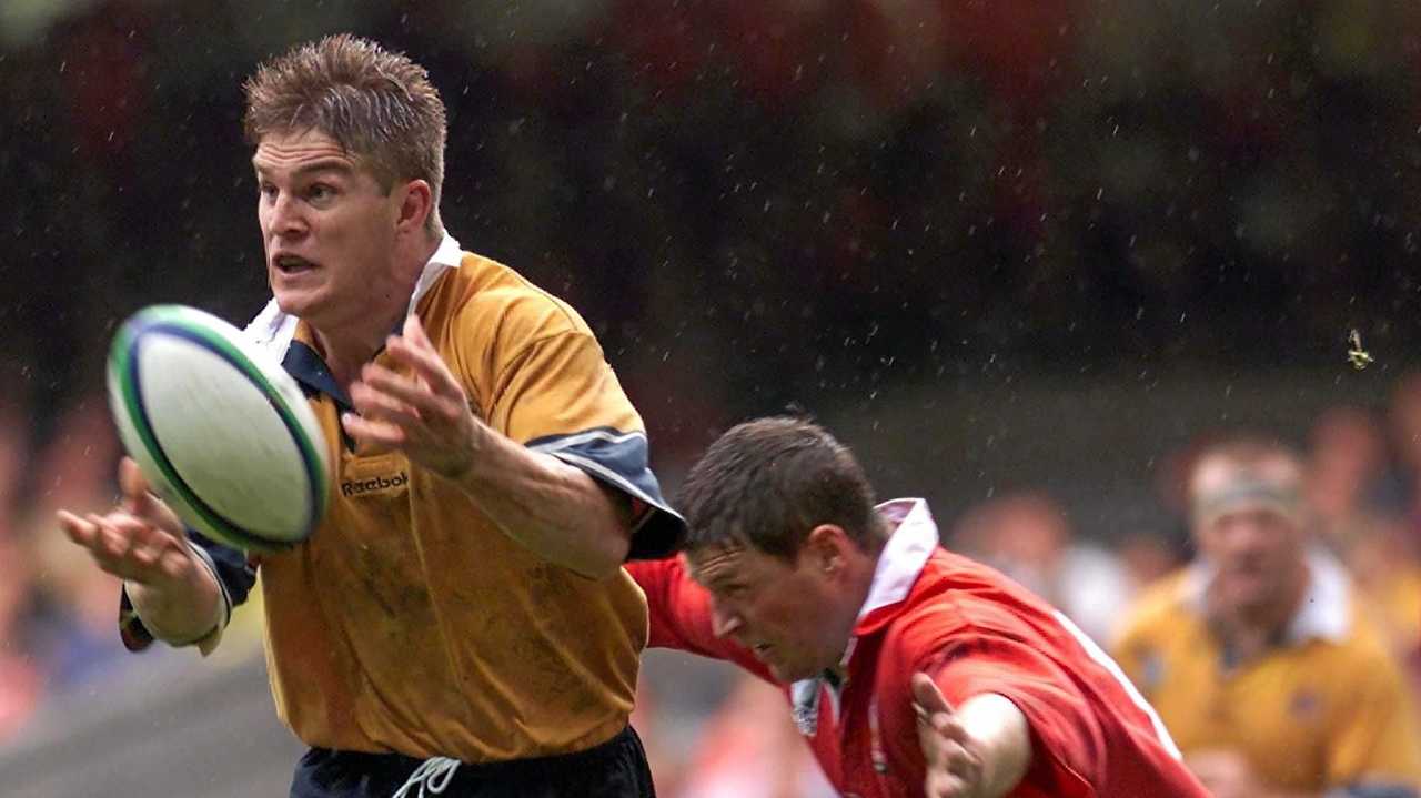 Australia's Tim Horan, left, being tackled by Wales's Scott Gibbs as he receives the ball,during his country game against Wales in Millennium stadium, Cardiff, Wales , during their Rugby World Cup quarter-final match  Saturday October  23, 1999.(AP Photo/Max Nash). Picture: MAX NASH