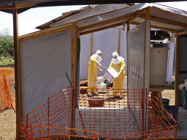 Healthcare workers prepare isolation and treatment areas for their Ebola  operations, in Gueckedou, Guinea.