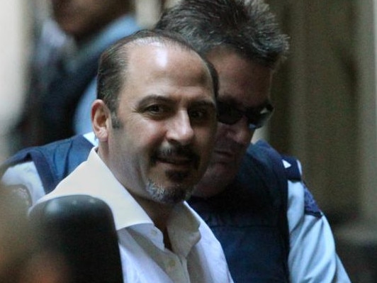 Tony Mokbel being led to court in 2011.