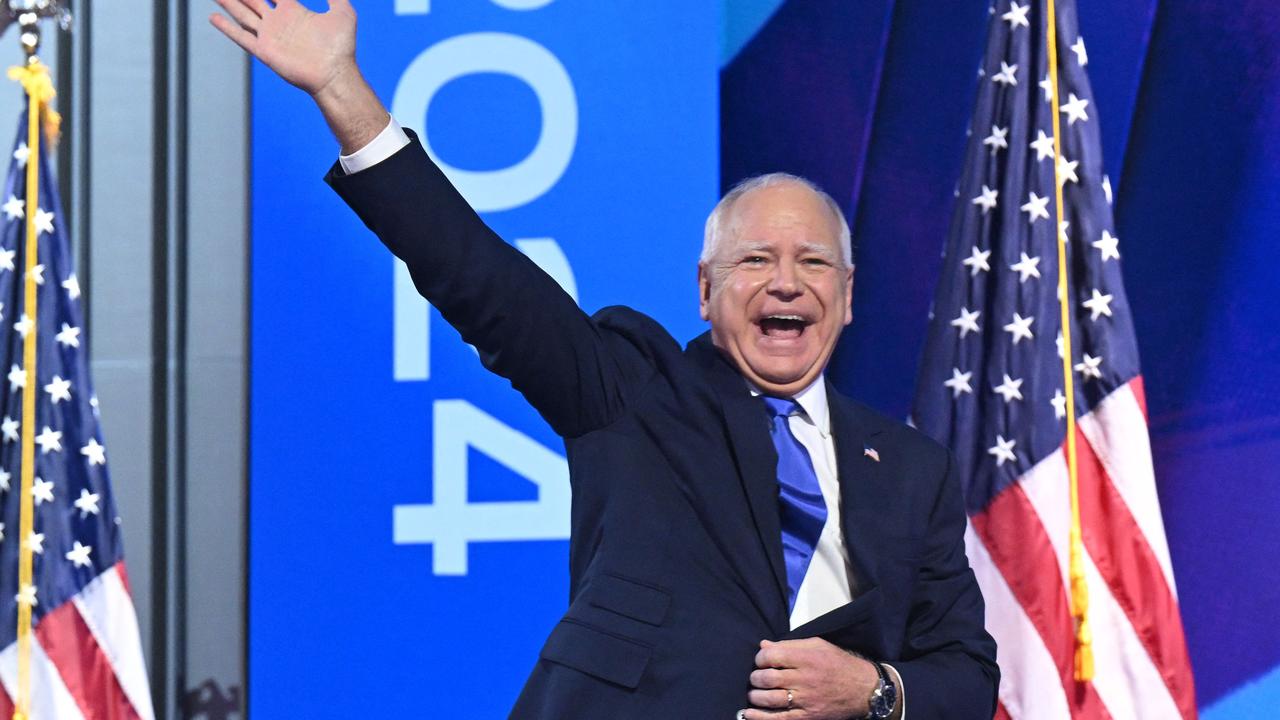 Minnesota Governor and 2024 Democratic vice presidential candidate Tim Walz waves as he arrives onstage to speak on the third day of the Democratic National Convention (DNC) at the United Center in Chicago, Illinois, on August 21, 2024. (Photo by SAUL LOEB / AFP)