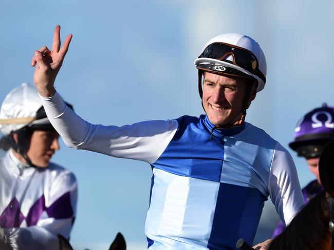 The man who can do no wrong in Queensland: jockey Blake Shinn celebrates his dead-heat success aboard Rudy. Picture: AAP