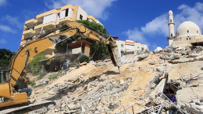 Rescuers dig through the rubble of a building, a day after it was hit in an Israeli strike, in Ain El Delb. Picture: Mahmoud Zayyat/AFP