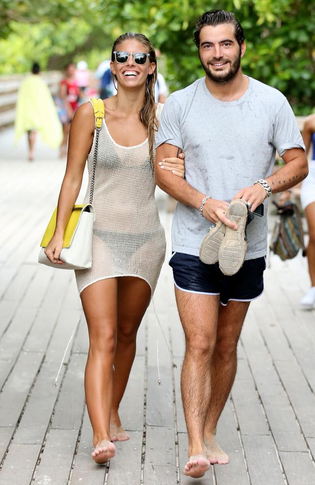 Home time ... Australian "Bikini a Day" founder Natasha Oakley and boyfriend Martin Medus leave a Florida beach to continue her 23rd birthday celebrations.