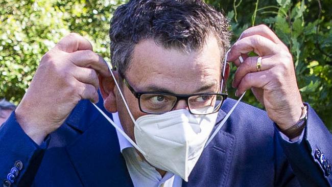 MELBOURNE, AUSTRALIA - NewsWire Photos February 17, 2022: (L-R) Victorian Premier Daniel Andrews puts on a mask after a press conference at Parliament. Picture: NCA NewsWire / Aaron Francis