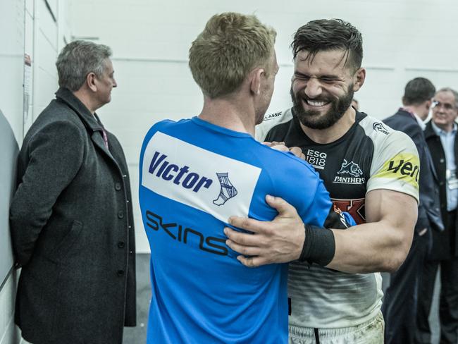 The rookie coach and recent teammate Josh Mansour share a moment after the match.