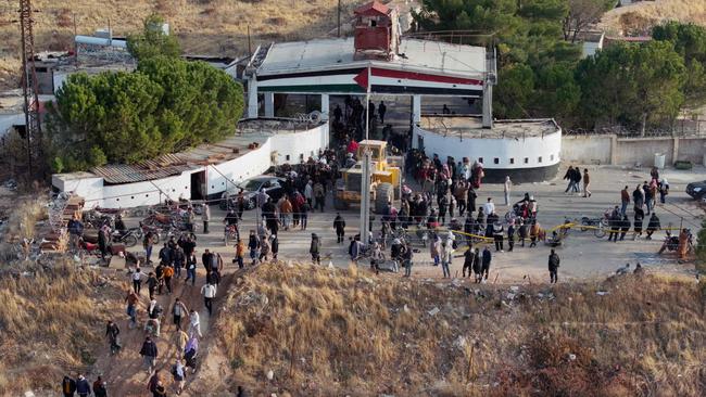 Syrians gather at the main entrance of the Sednaya prison in Damascus to find their relatives. Picture: AFP.