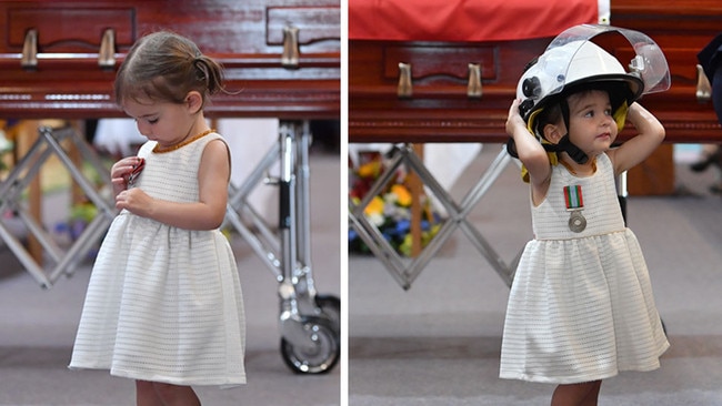 RFS volunteer Andrew O'Dwyer's daughter Charlotte next to his casket.