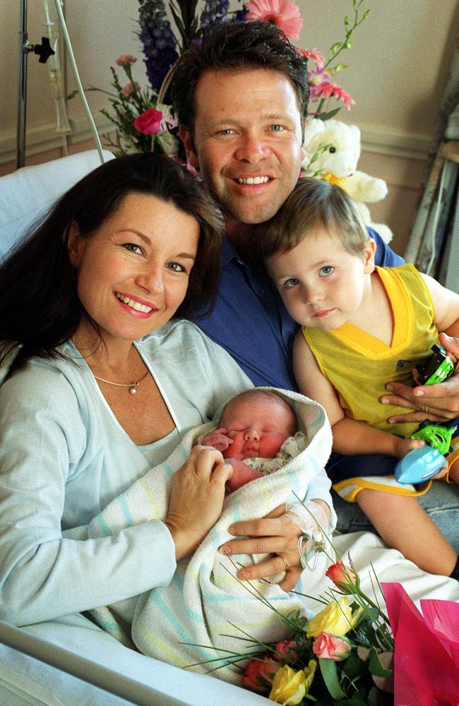 Laurel Edwards and Troy Cassar-Daley in hospital with Jem as a baby and her brother Clay, 2, in 2001. Picture: Steve Polhner