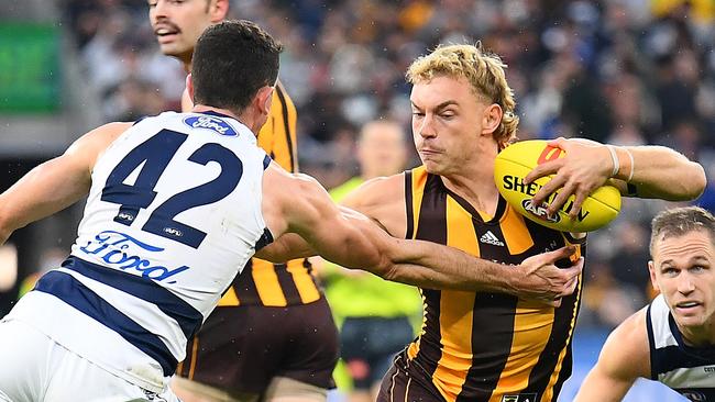 MELBOURNE, AUSTRALIA - APRIL 18: James Worpel of the Hawks fends off a tackle by Mark O'Connor of the Cats during the round five AFL match between the Hawthorn Hawks and the Geelong Cats at Melbourne Cricket Ground on April 18, 2022 in Melbourne, Australia. (Photo by Quinn Rooney/Getty Images)