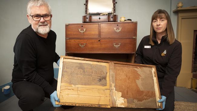 Conservation Project Officer of the Port Arthur collections Michael Smith and Visitor Services Officer Jennifer Dixon with a draw repaired with a Keens and Robinson crate of a chest of draws campaign furniture built in 1840 and owned by convict John Charles Tapp. Picture Chris Kidd