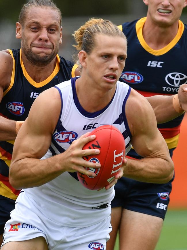 Femantle’s Nat Fyfe is chased by Crow Cam Ellis-Yolmen. Picture: David Mariuz/AAP