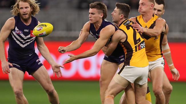 PERTH, AUSTRALIA – AUGUST 10: Caleb Serong of the Dockers handballs during the round 11 AFL match between the Fremantle Dockers and the Hawthorn Hawks at Optus Stadium on August 10, 2020 in Perth, Australia. (Photo by Paul Kane/Getty Images)