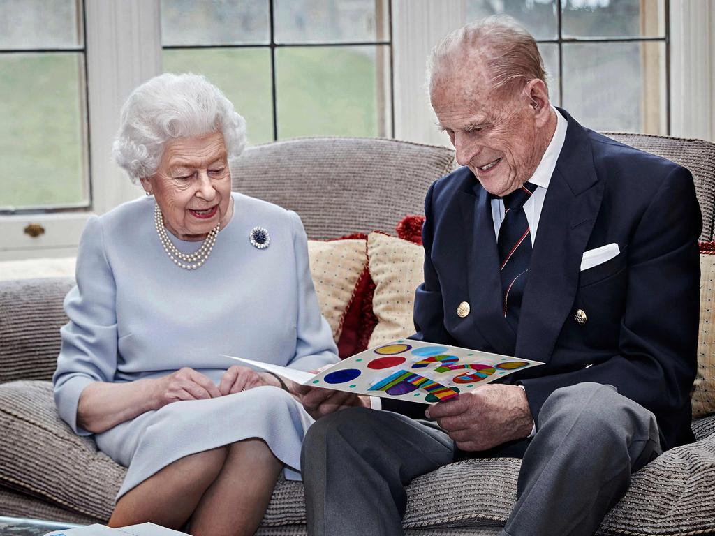 In one of the last official photos released of Prince Philip, he’s seen here enjoying reading a homemade wedding anniversary card, given to them by their great grandchildren, Prince George, Princess Charlotte and Prince Louis in the Oak Room at Windsor Castle on November 17, 2020. Picture: Chris Jackson/ AFP