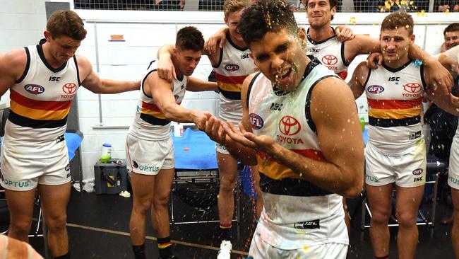 Tyson Stengle of the Crows celebrates during the team song following the win over the Suns. Picture: AAP Image/Dave Hunt