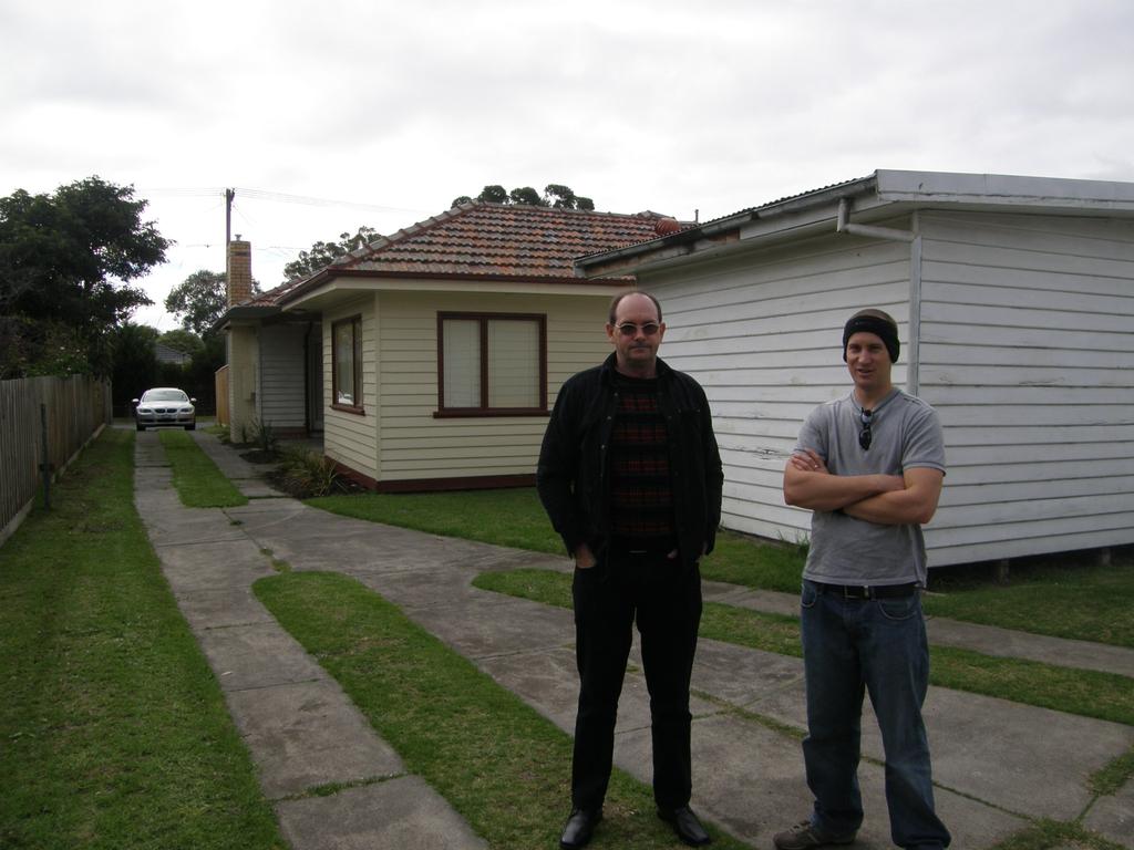 Mr Harris with a friend at an investment property in Seaford in Victoria.
