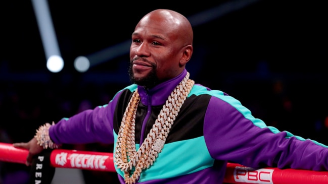 Floyd Mayweather forgets to dress up as he poses next to superstar