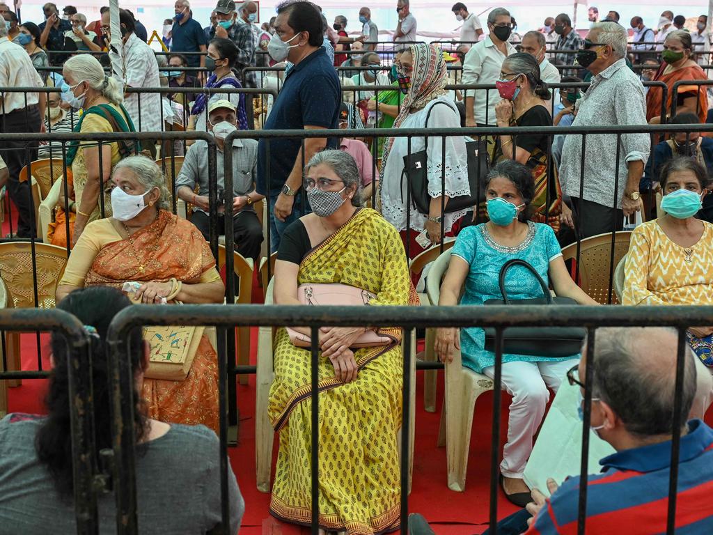 People queue up to receive a dose of vaccine at a vaccination centre in Mumbai. Picture: AFP