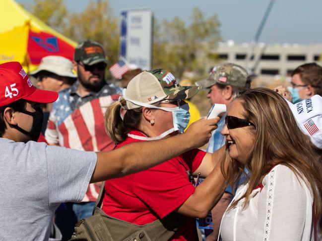 Trump supporters line up for temperature checks in Arizona where the US President was appearing. Picture: Getty Images/AFP