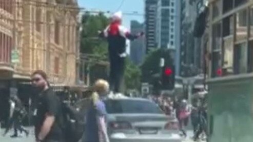 Video also shows the man standing on top of his car shouting.