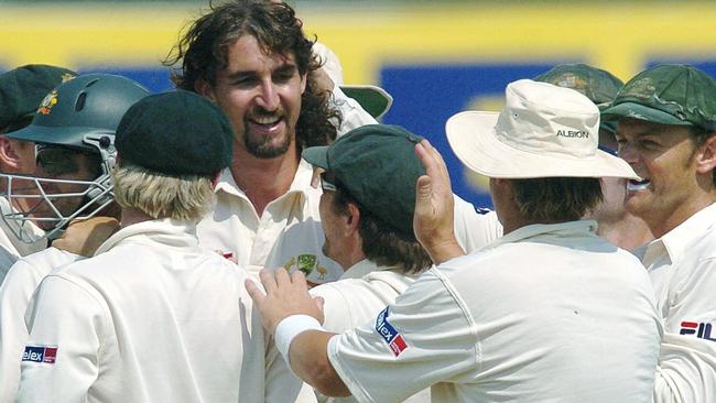 Australian bowler Jason Gillespie is congratulated by teammates after taking a wicket during the third Test against India in 2004.