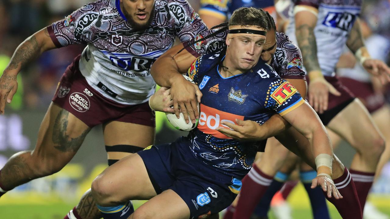 Jarrod Wallace of the Titans is tackled against Manly