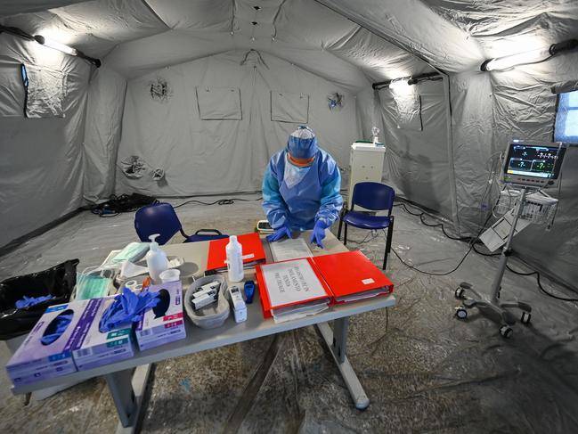 A medical worker wearing a protective suit and face mask stands in the first aid tent where patients suffering from coronavirus disease (COVID-19) are being treated at the Policlinico di Tor Vergata hospital in Rome. Picture: AFP