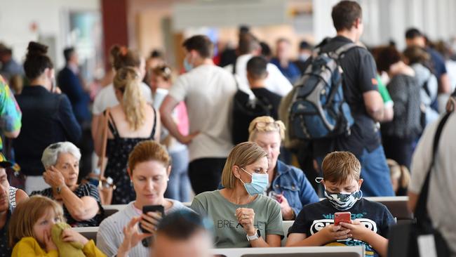 People wait for flights at Adelaide Airport on Monday. Picture: David Mariuz