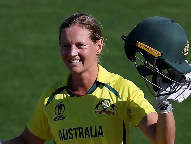 (FILES) In this file photo taken on March 22, 2022 Australia's captain Meg Lanning celebrates after reaching her century (100 runs) during the Women's Cricket World Cup match between Australia and South Africa at the Basin Reserve in Wellington on March 22, 2022. - Waiting tables in her local cafe and hanging out with friends and family helped rekindle Meg Lanning's love of cricket and intensified her drive to steer top-ranked Australia to another Twenty20 World Cup title this month.The decorated women's skipper took a indefinite months-long hiatus in 2022 after an intense few years, sparking fears she would not return. (Photo by Marty MELVILLE / AFP)