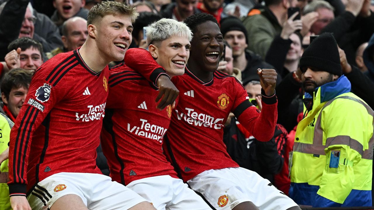 Manchester United's Argentinian midfielder #17 Alejandro Garnacho (C) celebrates after scoring his team second goal with Manchester United's Danish striker #11 Rasmus Hojlund (L) and Manchester United's English midfielder #37 Kobbie Mainoo during the English Premier League football match between Manchester United and West Ham United at Old Trafford in Manchester, north west England, on February 4, 2024. (Photo by Paul ELLIS / AFP) / RESTRICTED TO EDITORIAL USE. No use with unauthorized audio, video, data, fixture lists, club/league logos or 'live' services. Online in-match use limited to 120 images. An additional 40 images may be used in extra time. No video emulation. Social media in-match use limited to 120 images. An additional 40 images may be used in extra time. No use in betting publications, games or single club/league/player publications. /