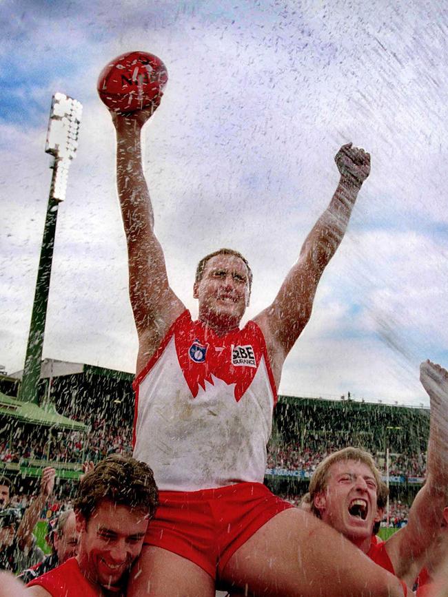 Lockett holds the ball aloft after the Swans smashed Collingwood in 1999.