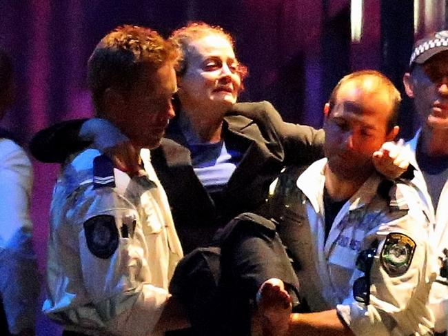 A woman is carried out by police from the Lindt Cafe, Martin Place following the hostage standoff. Picture: Getty Images