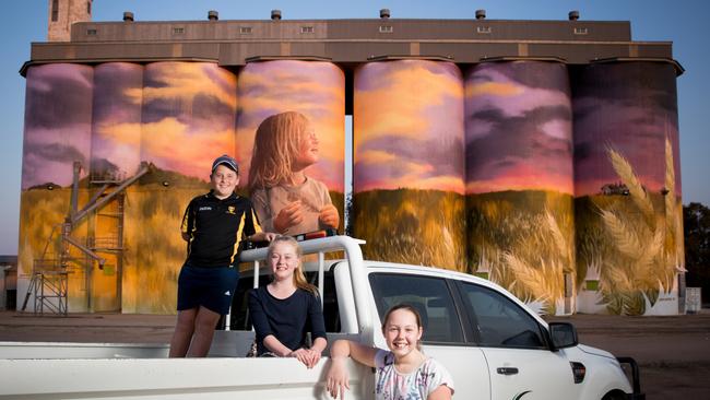 Seth Gregory, Tanna Maitland and Holly Woolford in front of the giant mural at Kimba. Picture: Robert Lang