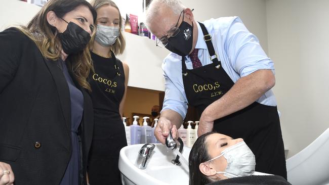 Scott Morrison bizzarely thought it would be a good idea to wash a woman’s hair at Coco's Hair Salon in Victoria. Picture: Andrew Henshaw