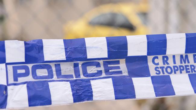 Blue and white Police tape cordoning off a area with a yellow car at a industrial area, Australia 2016Police tape cordoning off a area with a yellow car - Stock image  ipad generic